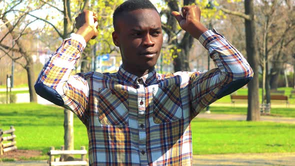 A Young Black Man Is Angry in a Park on a Sunny Day