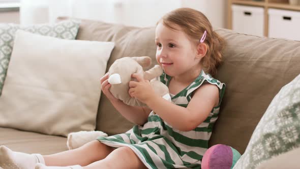 Baby Girl Playing with Toy Rabbit at Home 4