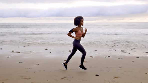 Slow motion shot of an Somali woman jogging on the beach