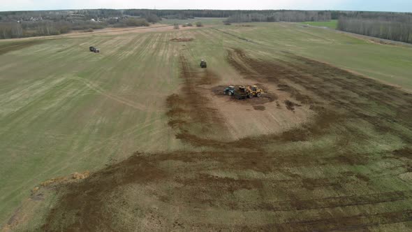 Loader Loads the Smelly Manure Into the Spreaders for Fertilizing the Land