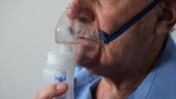 Close Up of Senior Man Using Nebulizer