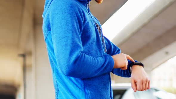 Young man checking his smartwatch on the street, 4K 4k