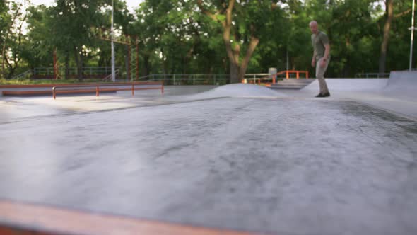 Skateboarder Doing a Tricks in a Concrete Skate Park Close Up Slow Motion