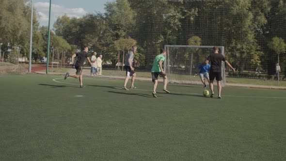 Cheerful Footballers Celebrating a Goal on Pitch