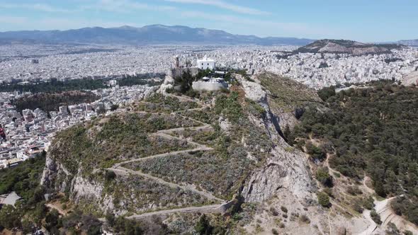 Rising drone video of Mount Lycabettus, in Athens, Greece.