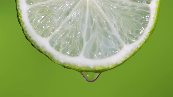 Fresh Slice Lime, a Drop of Water Falls. The Fruit Gives Off Freshness and Juice Filling. Green