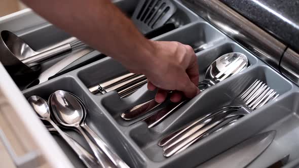 Cutlery for table setting in a pull-out kitchen drawer, close-up