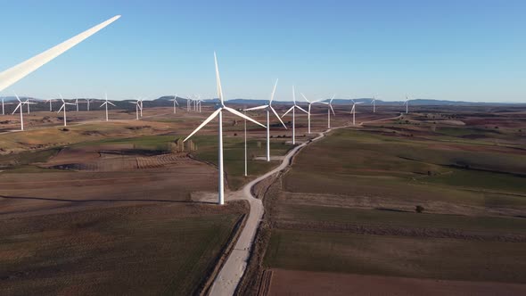 Windmills in field on sunny day