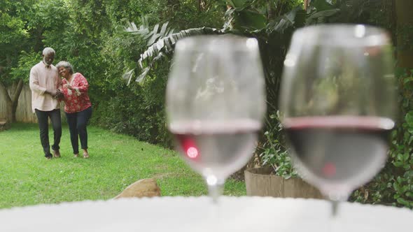 A senior african american couple spending time together in the garden social distancing in quarantin