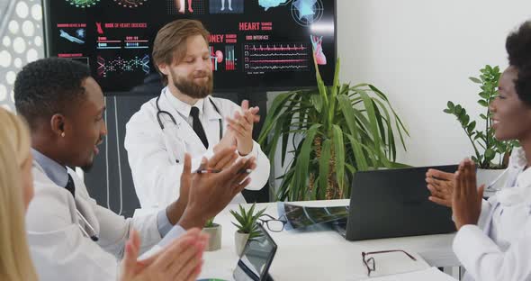 Doctors Clapping Hands as a Sign of Successful Ending of Seminar