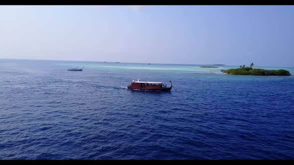 Aerial above seascape of relaxing resort beach trip by blue water and clean sandy background of a pi