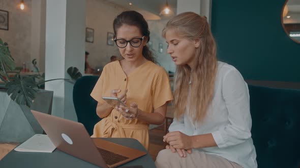 Two Girls Meet in a Coffee Shop