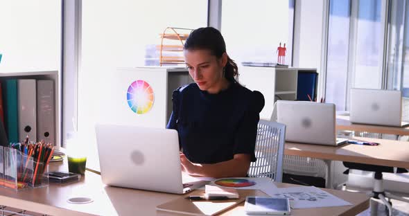 Female executive working at her desk in office 4k