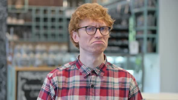 Young Redhead Man Shaking Head in Disapproval No Sign