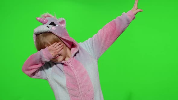 Little Blonde Child Girl Dancing Celebrating Performing Dab Dance in Unicorn Pajamas Costume