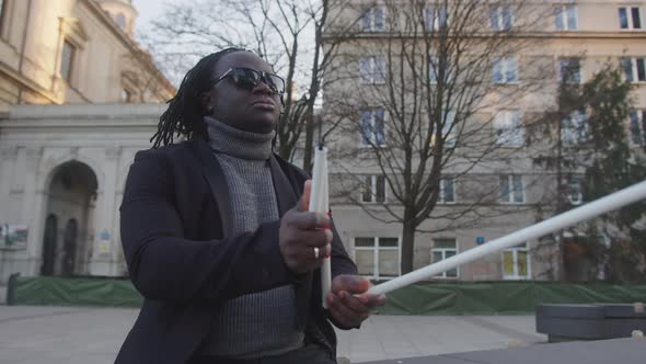 Blind African American Black Man with Sunglases Opening His Walking Stick and Walking Away From the