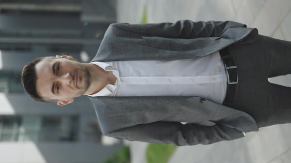 Vertical Video of Handsome Nice Entrepreneur in Formal Suit Standing Outside Work