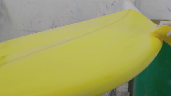 Male surfboard maker in his workshop