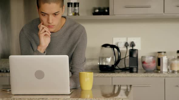 Man using laptop at home 4k