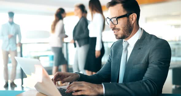 Young Handsome Architect Working on Laptop in Office