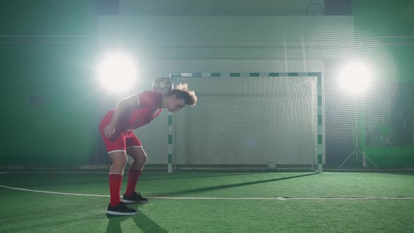 Professional Football Player Performs a Series of Tricks with a Soccer Ball Balances the Ball on
