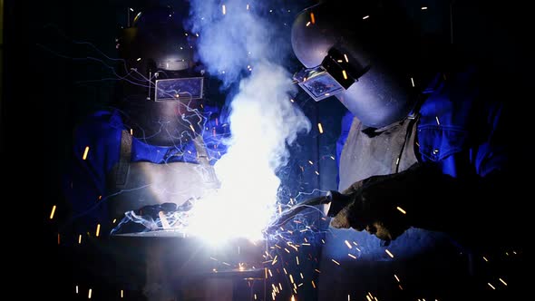 Welders welding a metal