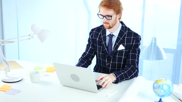 Redhead Businessman Working On Laptop in Office, Creative Freelancer Designer
