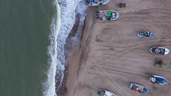 Aerial Over a Sandy Beach and Fishing Boats Standing Ashore