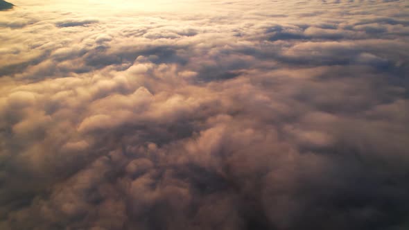 4K Drone Flying through the clouds at dusk or dawn. Aerial top cloudscape