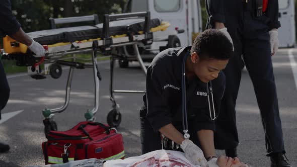 African American Emergency Doctor Doing Cardiac Massage to Man