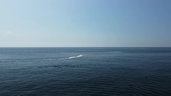 Happy People Swim on Air Mattress Behind a High Speed Water Bike