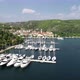 Aerial view of white sailboats and yachts embarked in a marina with turquoise, water - VideoHive Item for Sale