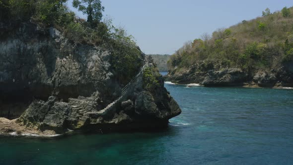 rock island in crystal bay of nusa penida bali during a sunny day surrounded by tropical water, aeri