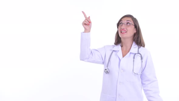 Happy Beautiful Woman Doctor Talking While Pointing Up