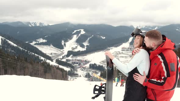 Loving Couple in Sporty Wearing on Mountain at Ski Resort