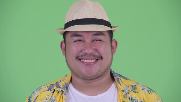 Face of Happy Young Overweight Asian Tourist Man Smiling
