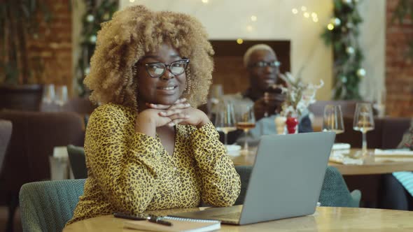 Portrait of Cheerful African American Businesswoman in Cafe