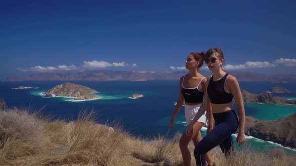 Two Travelling Women Climbing on the Hillside on a Sunny Afternoon Enjoying Their Hiking