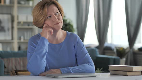 Portrait of Thinking Old Senior Woman in Office