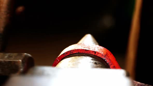 Close-up of blacksmith working on a iron rod