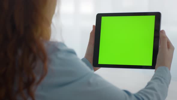 Close Up of Unrecognizable Girl Watching Videos Online on Digital Tablet with Green Chroma Key