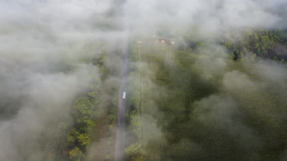 Drone Flight Over the Road High in the Morning Fog