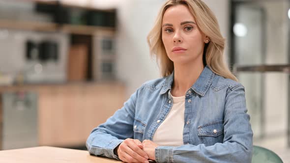 Serious Young Casual Woman Looking at the Camera 