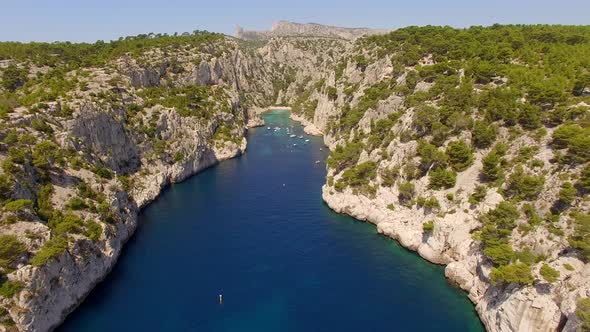 Aerial travel drone view of clear green water, cliffs of Cassis, Mediterranean Sea, Southern France.