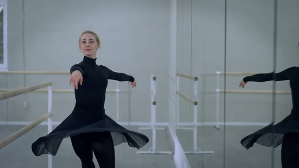 Medium Shot Portrait of Smiling Positive Beautiful Ballerina Doing Pirouette Reflecting in Mirror