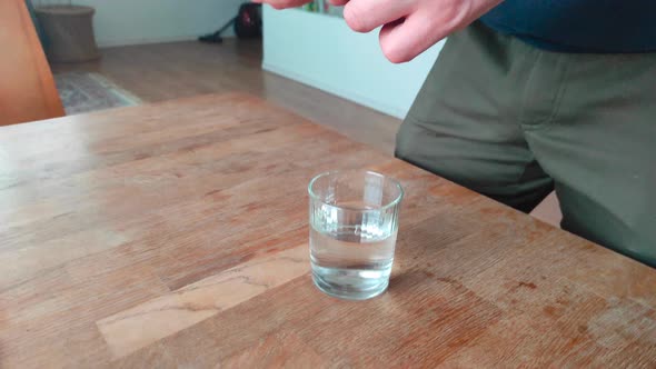 Man Drink Pill with Water From Glass