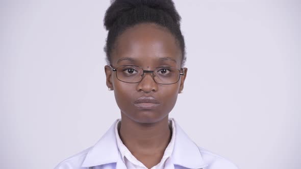 Face of Young African Woman Doctor Covering Mouth As Three Wise Monkeys Concept