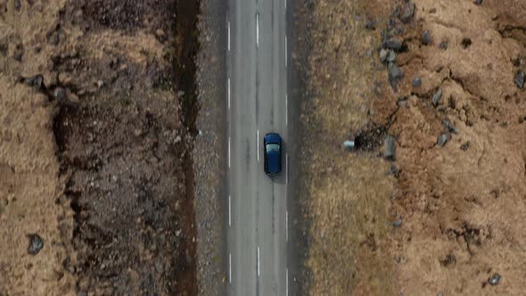 Drone Tracking Car Driving Along Road In Countryside