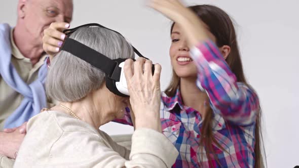 Woman Showing Virtual Reality to Elderly People