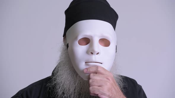 Mature Bearded Hipster Man Revealing Face Behind White Mask